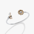 Alex And Ani flex cuff bracelet featuring a crystal sunflower and a bee charm.