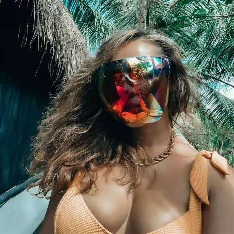 Futuristic iridescent full face shield sunglasses on a white background