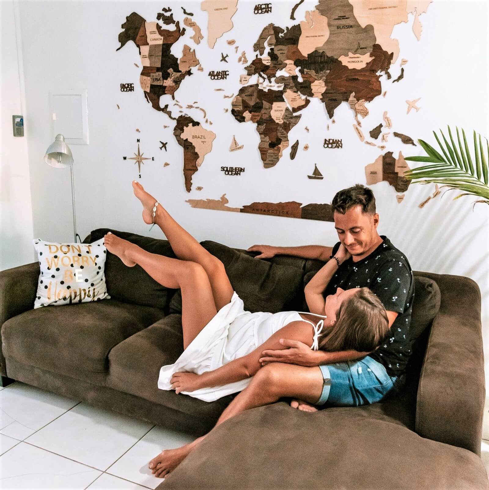 Modern wooden wall decor piece mounted on a living room accent wall
