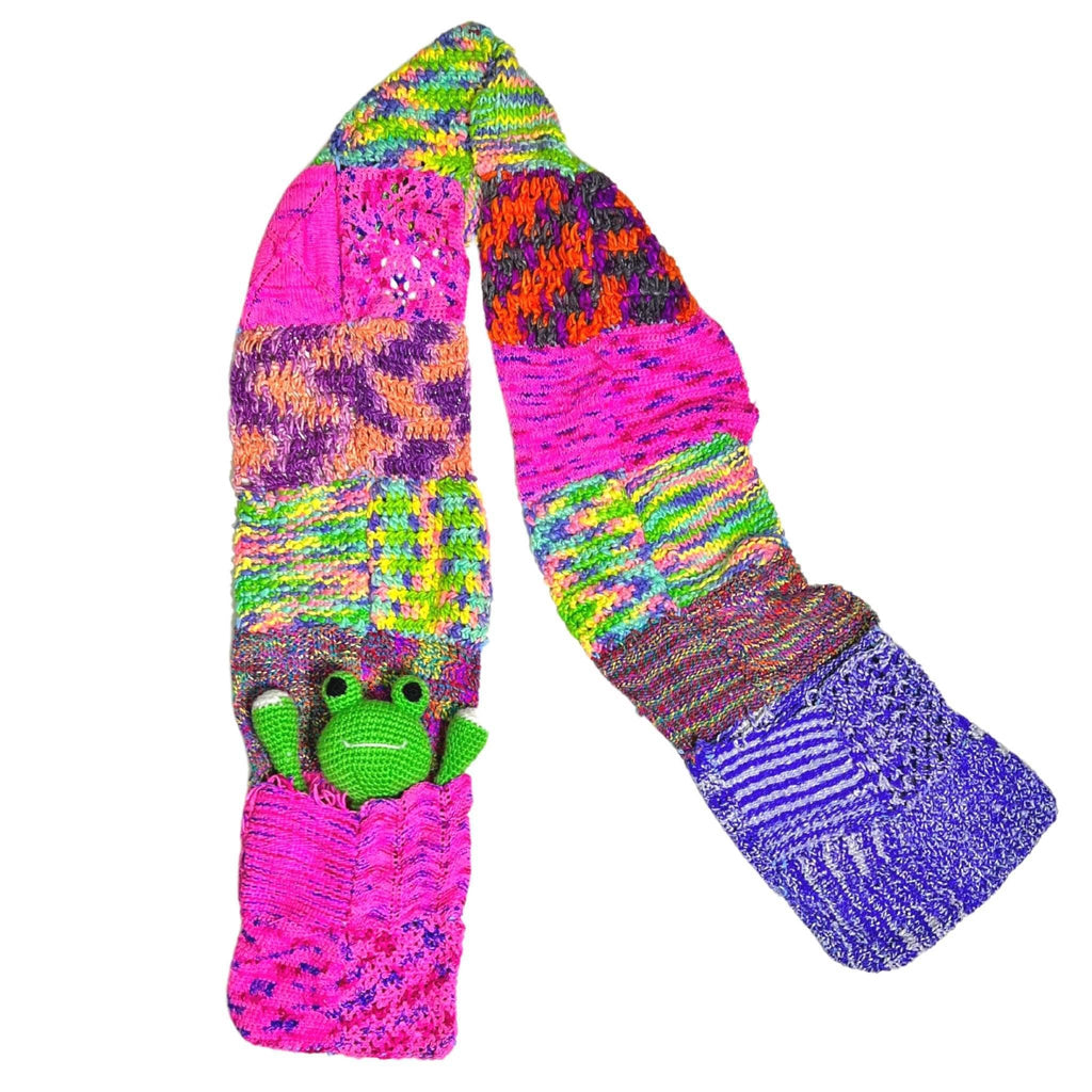 Vibrant neon patchwork knit scarf with pockets in shades of hot pink, blue, green, purple, and orange.