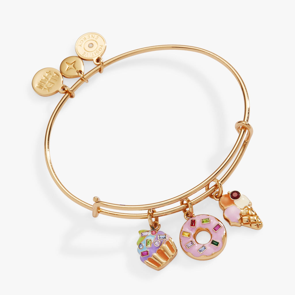 Gold-tone bangle featuring whimsical ice cream, cupcake, and donut charms with multi-colored details.