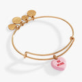 Expandable wire bangle featuring a pink heart-shaped candy charm engraved with 'Be Mine'.