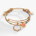 Set of two gold-tone expandable wire bangles with a Cutie Pie peach charm and Aren't You A sentiment charm.