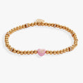 Sweethearts I Luv You beaded stretch bracelet with a pink and gold-tone candy heart charm.