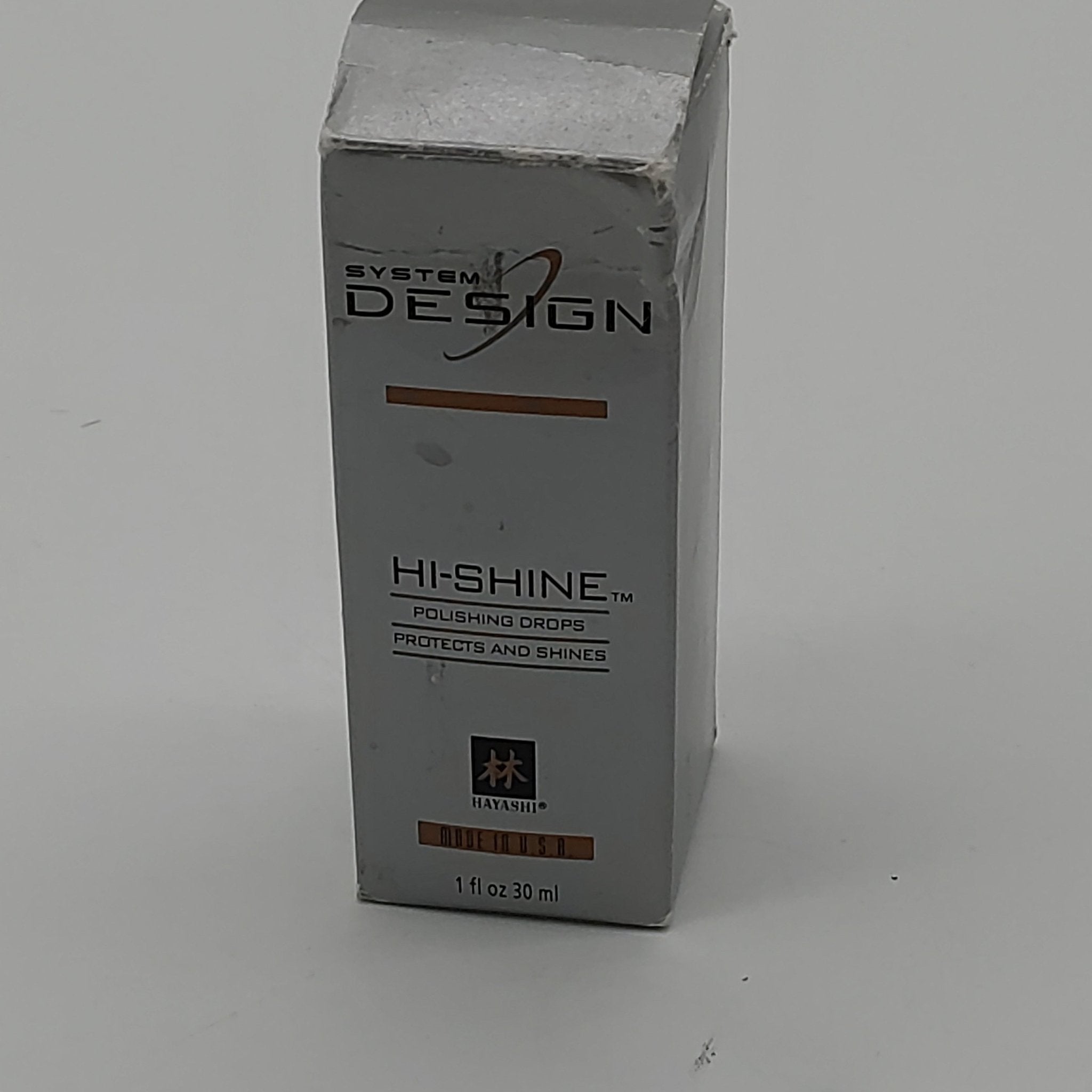 System Design Hi-Shine Polishing Drops bottle in silver and brown packaging