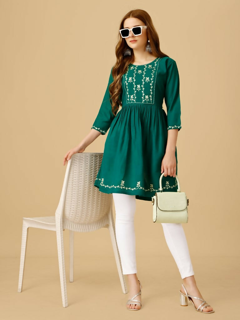 Women wearing a Rama colored viscose rayon embroidered casual top with sequence detail