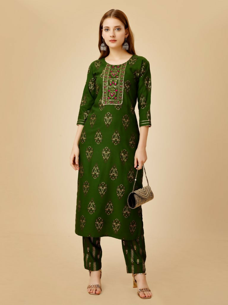 Women wearing a green embroidered straight kurta pant set in viscose rayon.