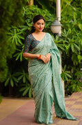 Mint green jute silk woven jacquard saree with Kalamkari printed blouse.