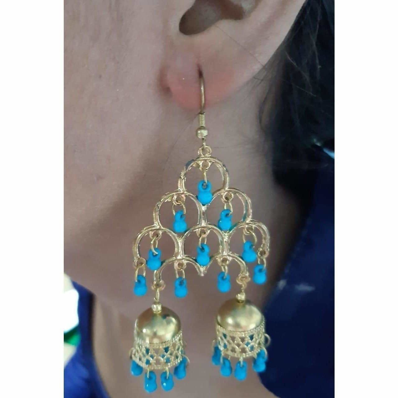Long gold-polished double jhumka earrings with blue pearl embellishments