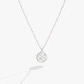 Double-sided Taurus zodiac pendant necklace with crystal accents on a delicate gold-tone chain.