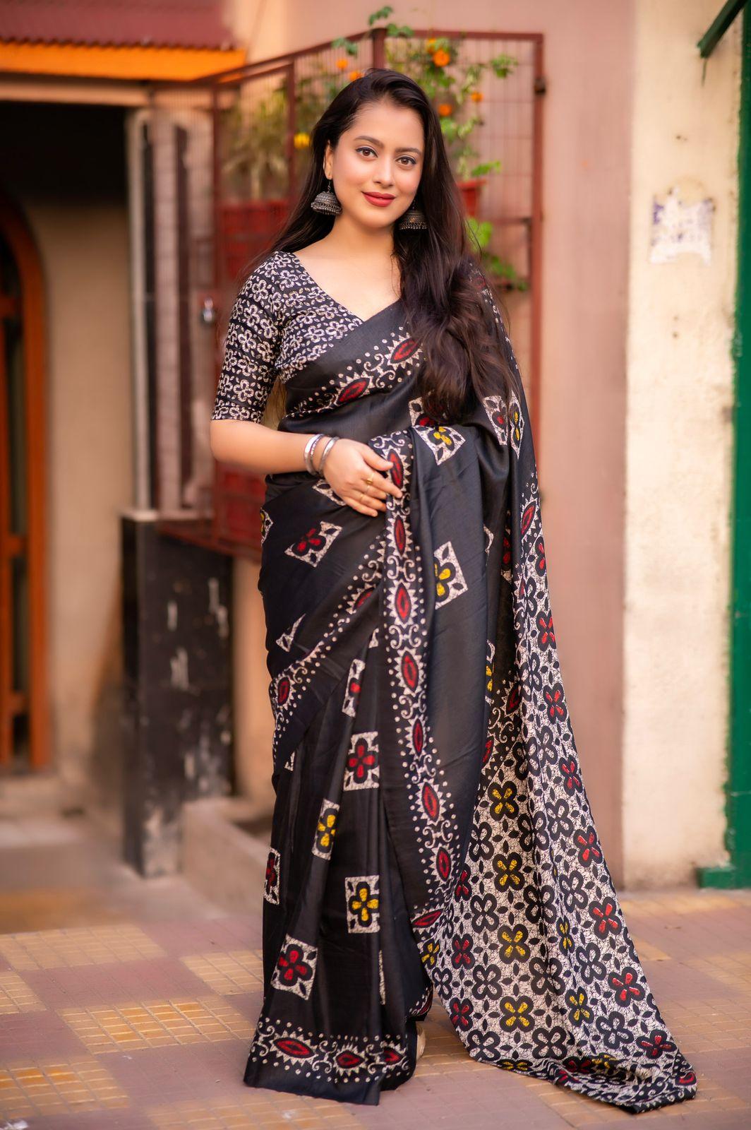 Black silk blend saree with traditional batik style prints and running blouse piece.
