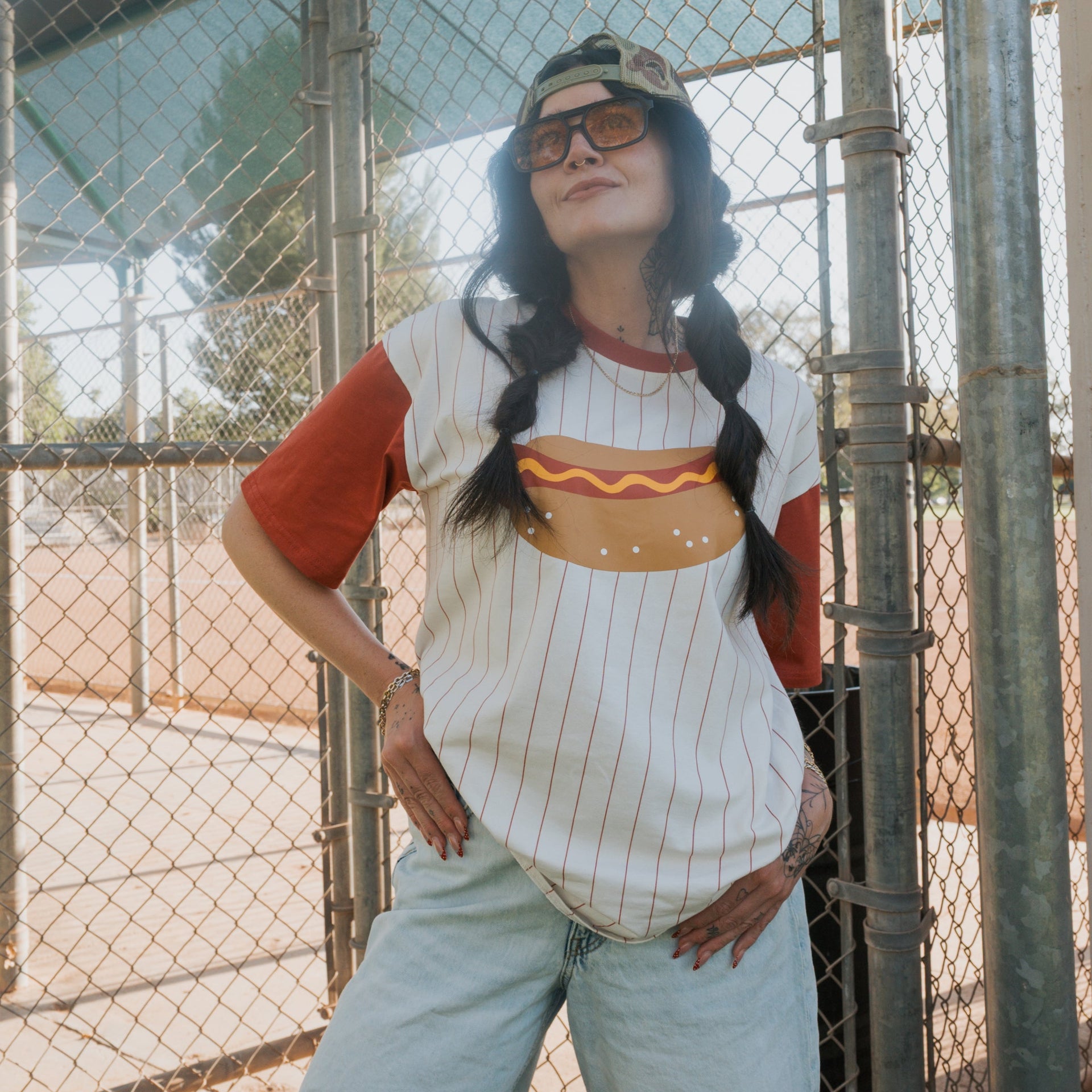 Unisex retro-sport t-shirt with striped pattern and hot dog graphic, available in white, rust, and mustard