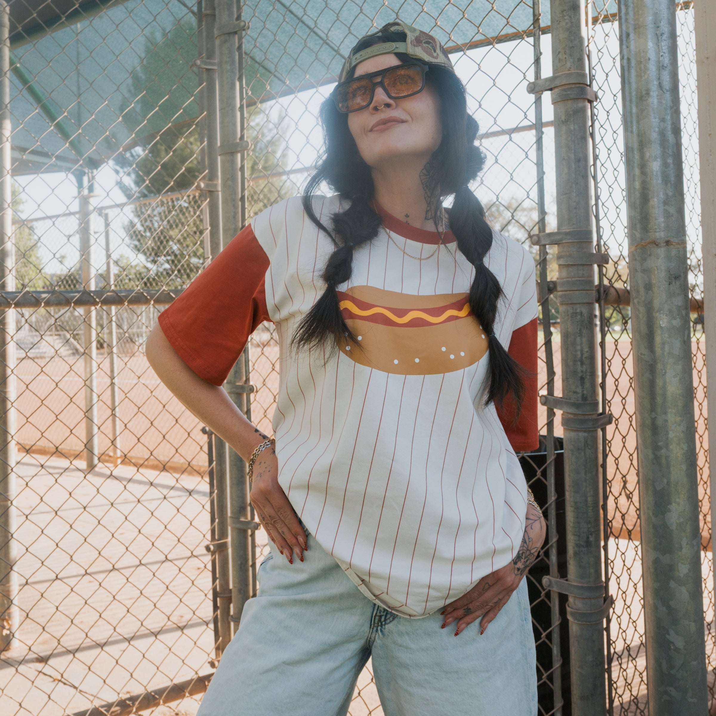 Unisex retro-sport t-shirt with striped pattern and hot dog graphic, available in white, rust, and mustard