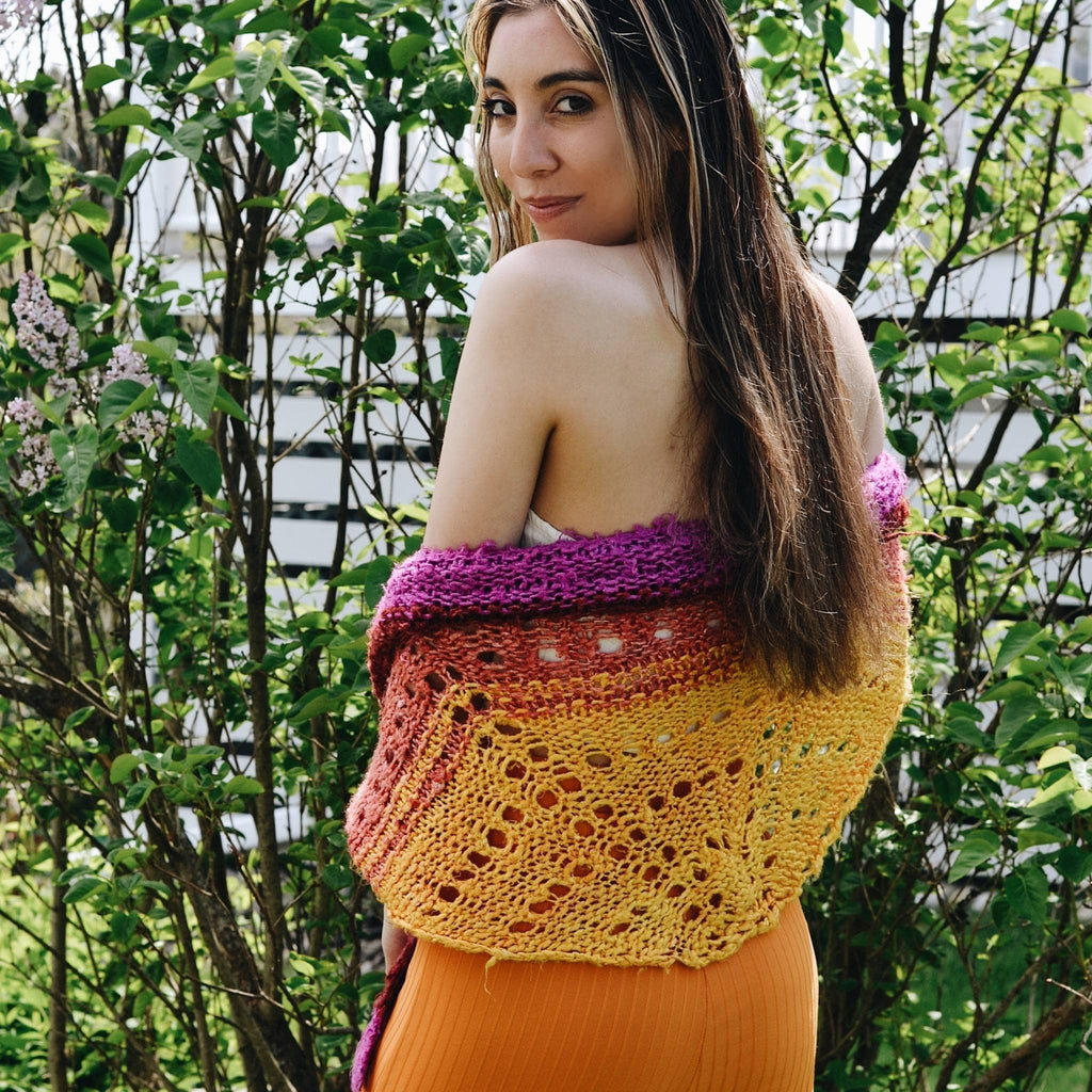 A beautiful ombre knitted shawl made from vibrant banana fiber yarn, displayed as part of a DIY craft kit.