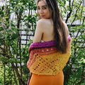 A beautiful ombre knitted shawl made from vibrant banana fiber yarn, displayed as part of a DIY craft kit.