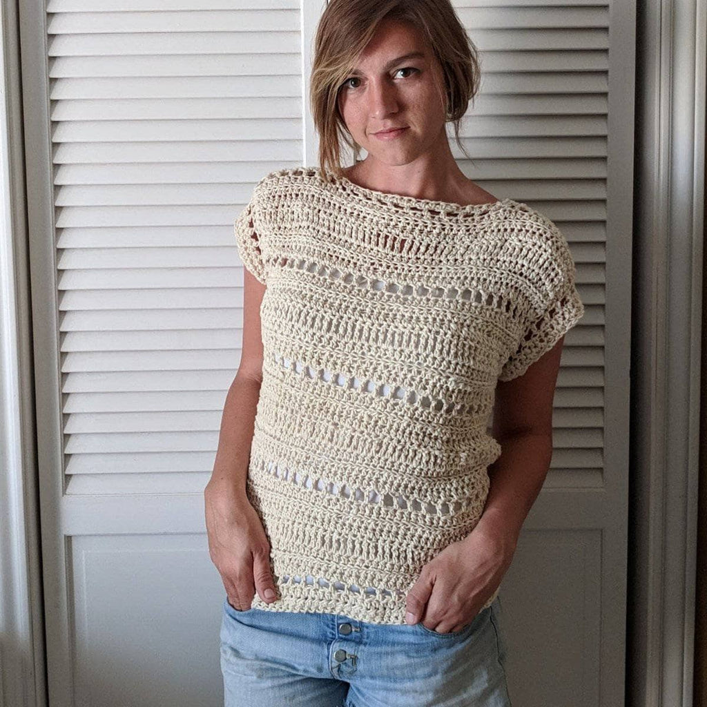 The Driftwood Tee displayed as a finished crochet garment with a cozy, textured stitch pattern.