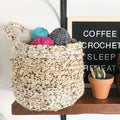 Handmade bohemian style Hayden hanging basket on a tabletop featuring a neutral cream and black geometric pattern