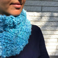 Close up of The Ocean Waves Cowl knitted with vibrant banana fiber yarn.