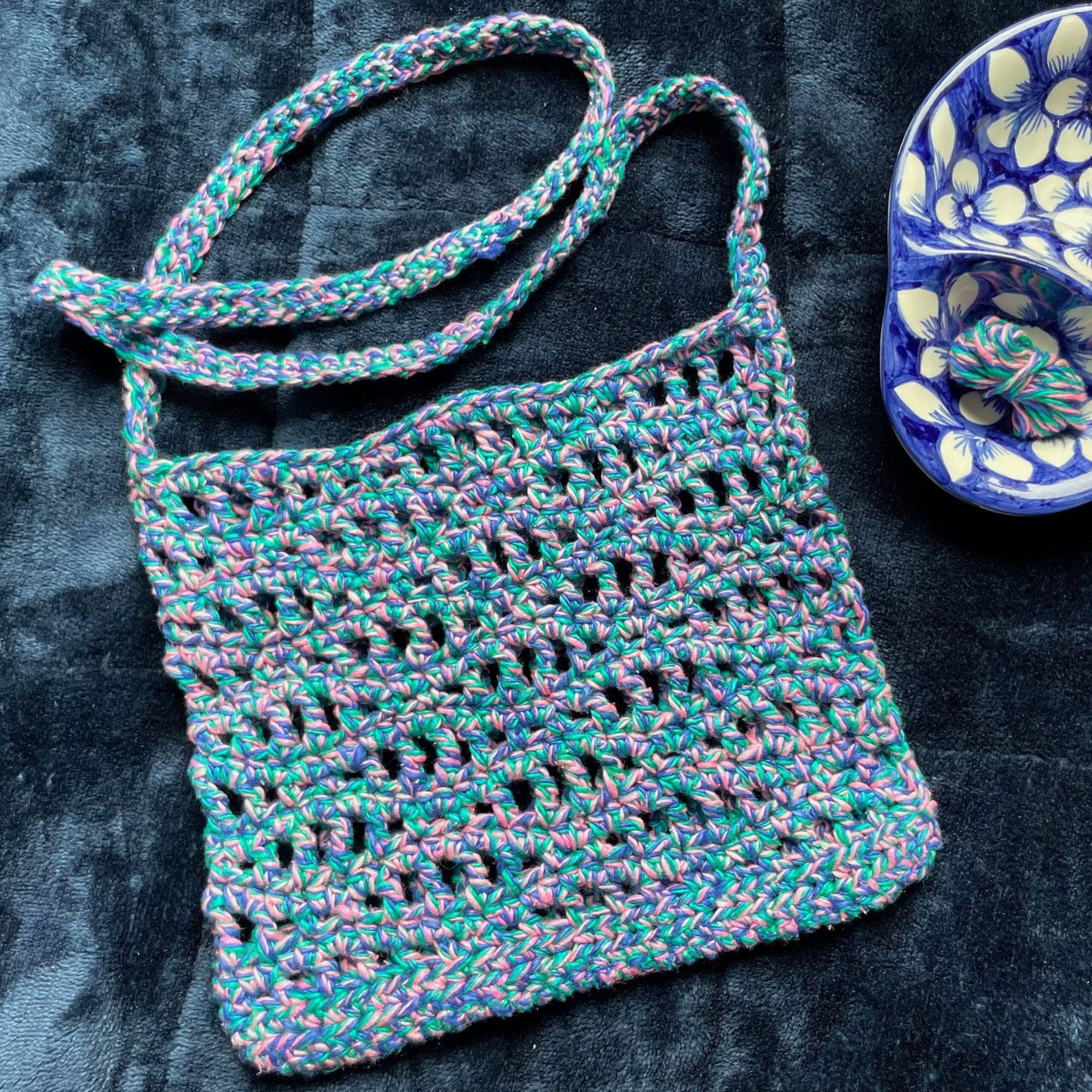 The Open Ocean Bag crochet pattern featuring open stitches and wave-crest detailing at the top