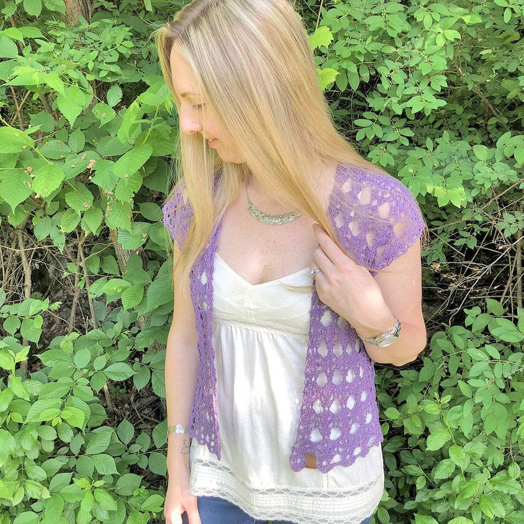 Close up of The Shenandoah Shrug crochet lace pattern in a neutral sport weight yarn