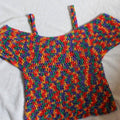 Multi-colored bohemian crochet top pattern with red, purple, green, and yellow hues