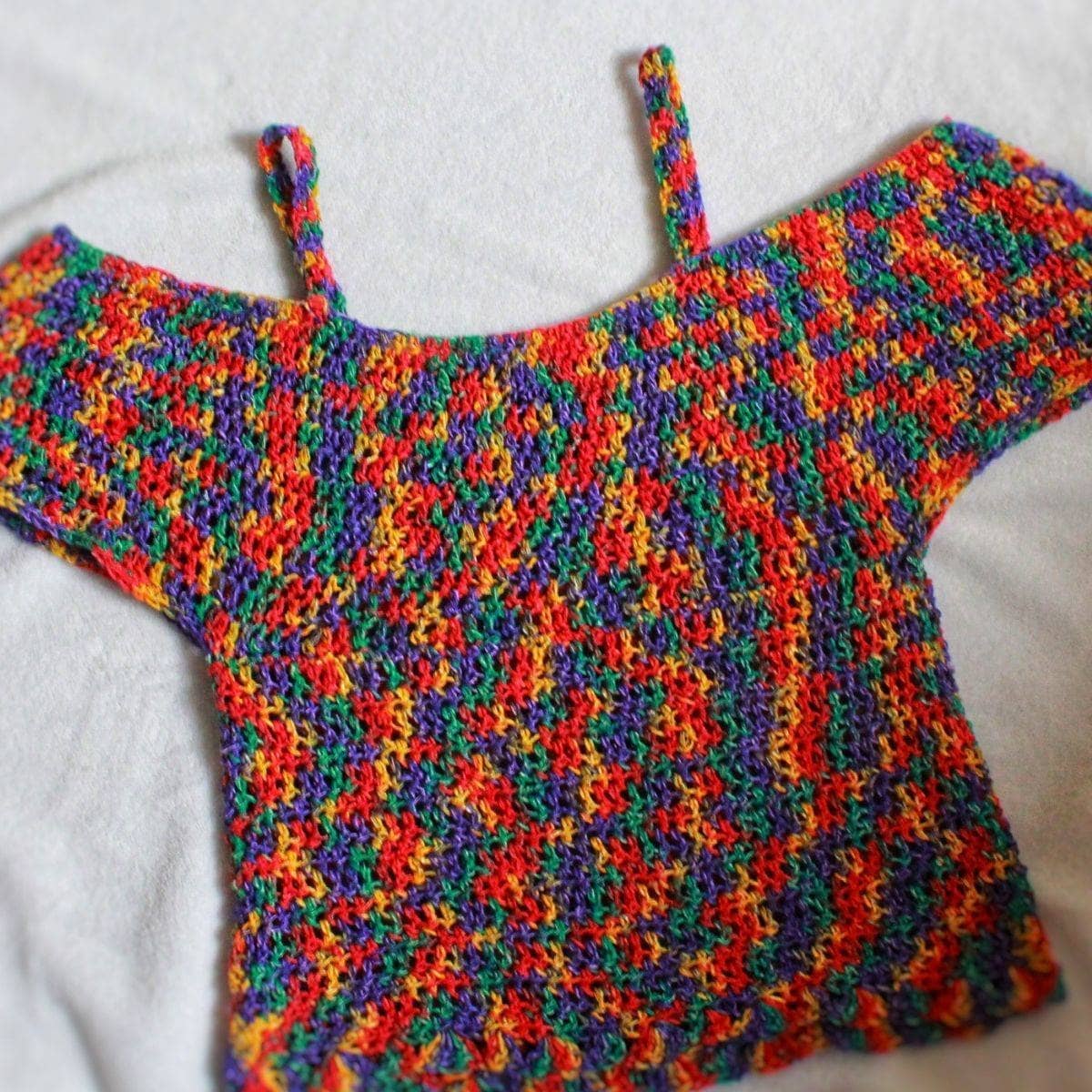 Multi-colored bohemian crochet top pattern with red, purple, green, and yellow hues