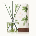 Thymes Frasier Fir reed diffuser in a glass bottle with pine green and woodgrain accents on a neutral background.