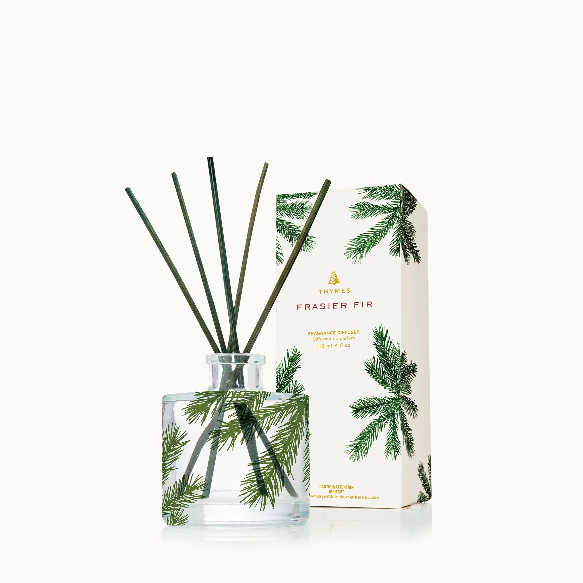 Thymes Frasier Fir Petite Pine Needle Reed Diffuser in a clear glass bottle with green pine accents.