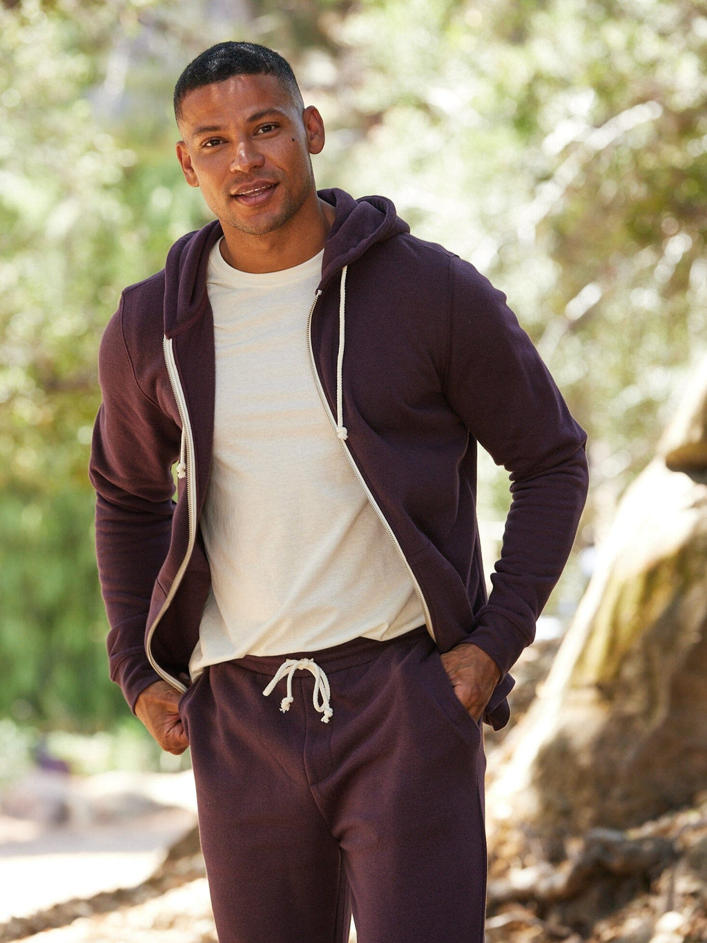 Men's Core Triblend Fleece Zip Hoodie in dark purple with off-white drawstrings and front pockets.