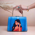 Blue clutch bag with women portrait print, ideal for traditional saree outfits