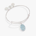 Bridal bangle with light blue 'To Have & To Hold' enamel charm on an expandable wire.