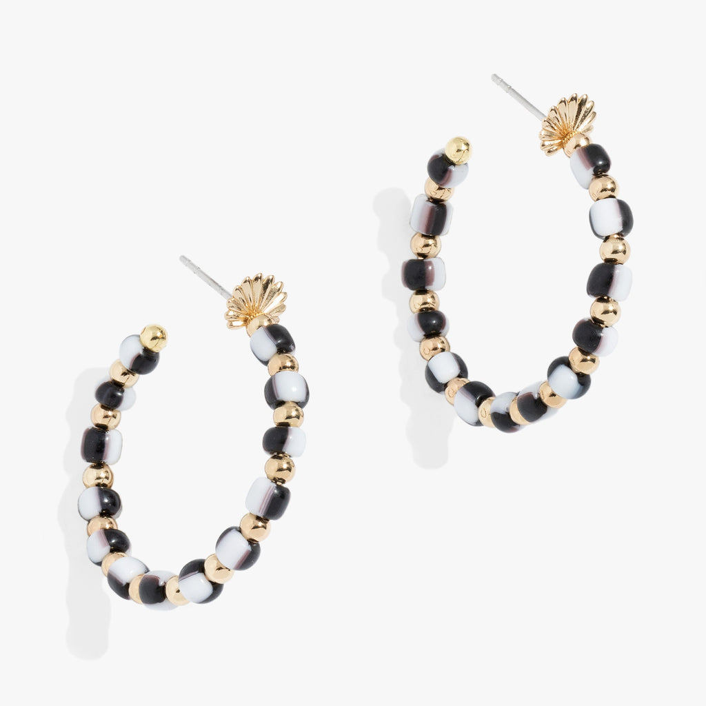 Toile Beaded Hoop Earrings featuring hand-painted patterns on a satin gold palm-inspired base.