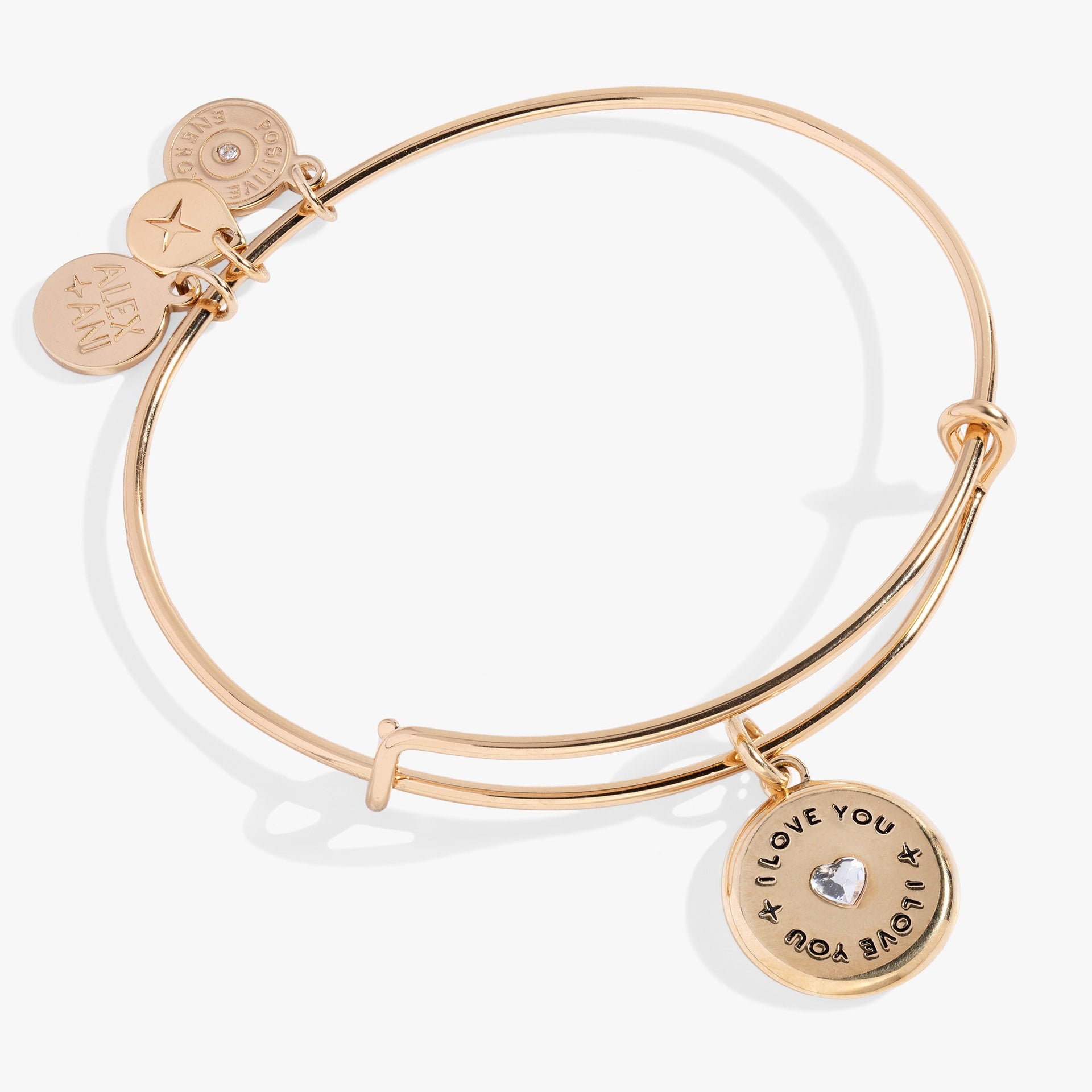 A romantic expandable charm bangle with a clear crystal heart and an I Love You engraving in gold and silver.