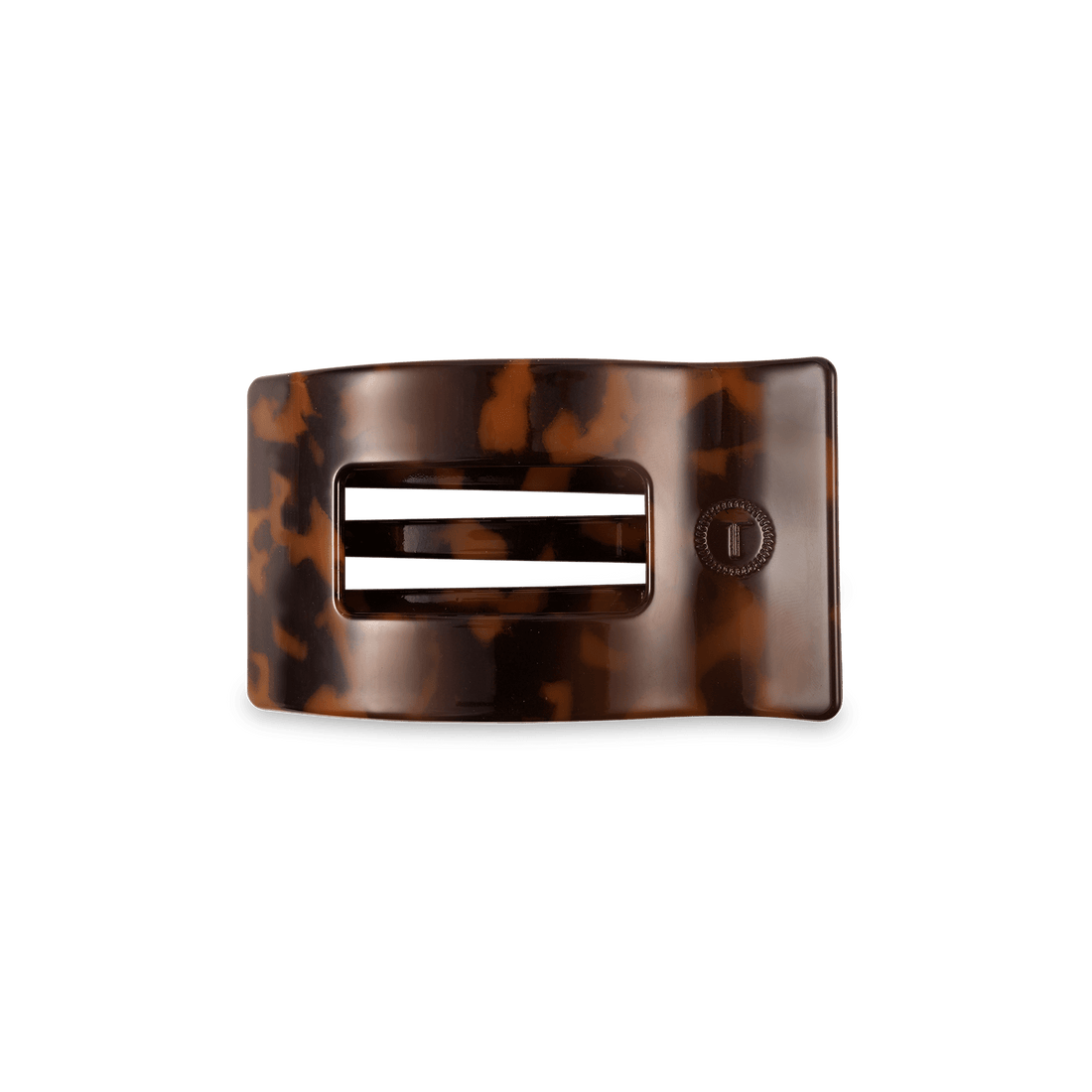 Small rectangular hair clip in a classic tortoise shell pattern resting on a flat surface