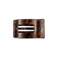 Small rectangular hair clip in a classic tortoise shell pattern resting on a flat surface