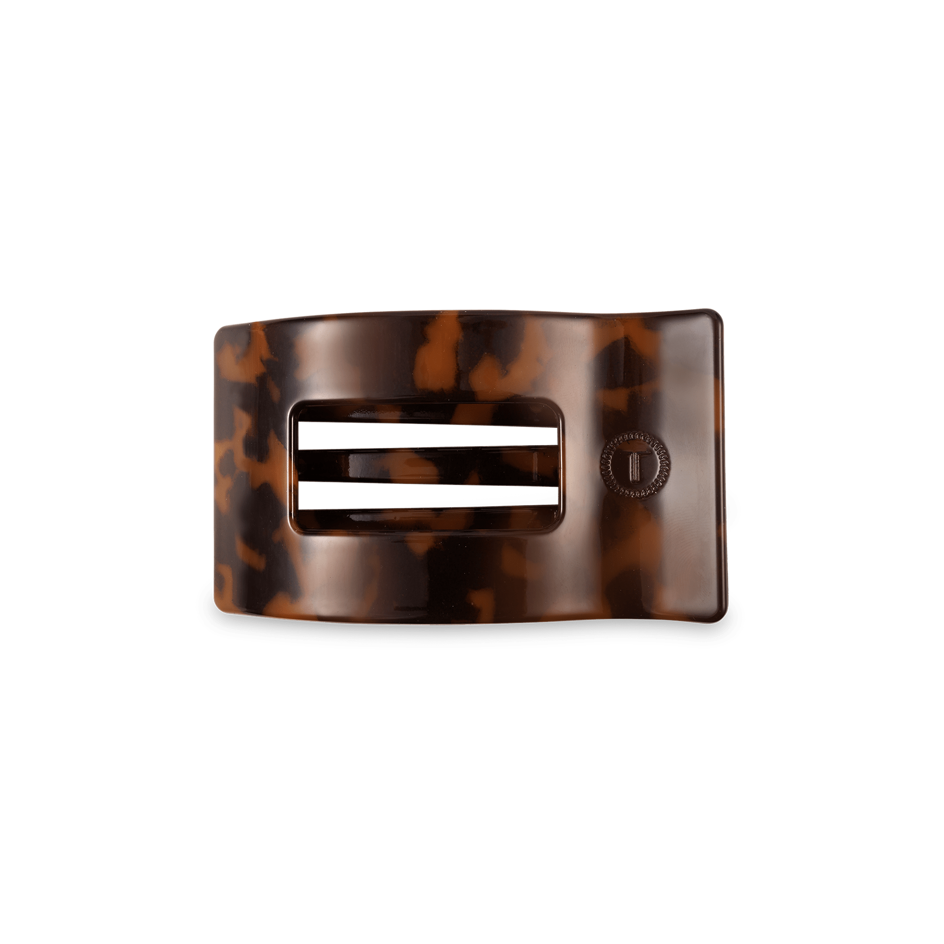Small rectangular hair clip in a classic tortoise shell pattern resting on a flat surface