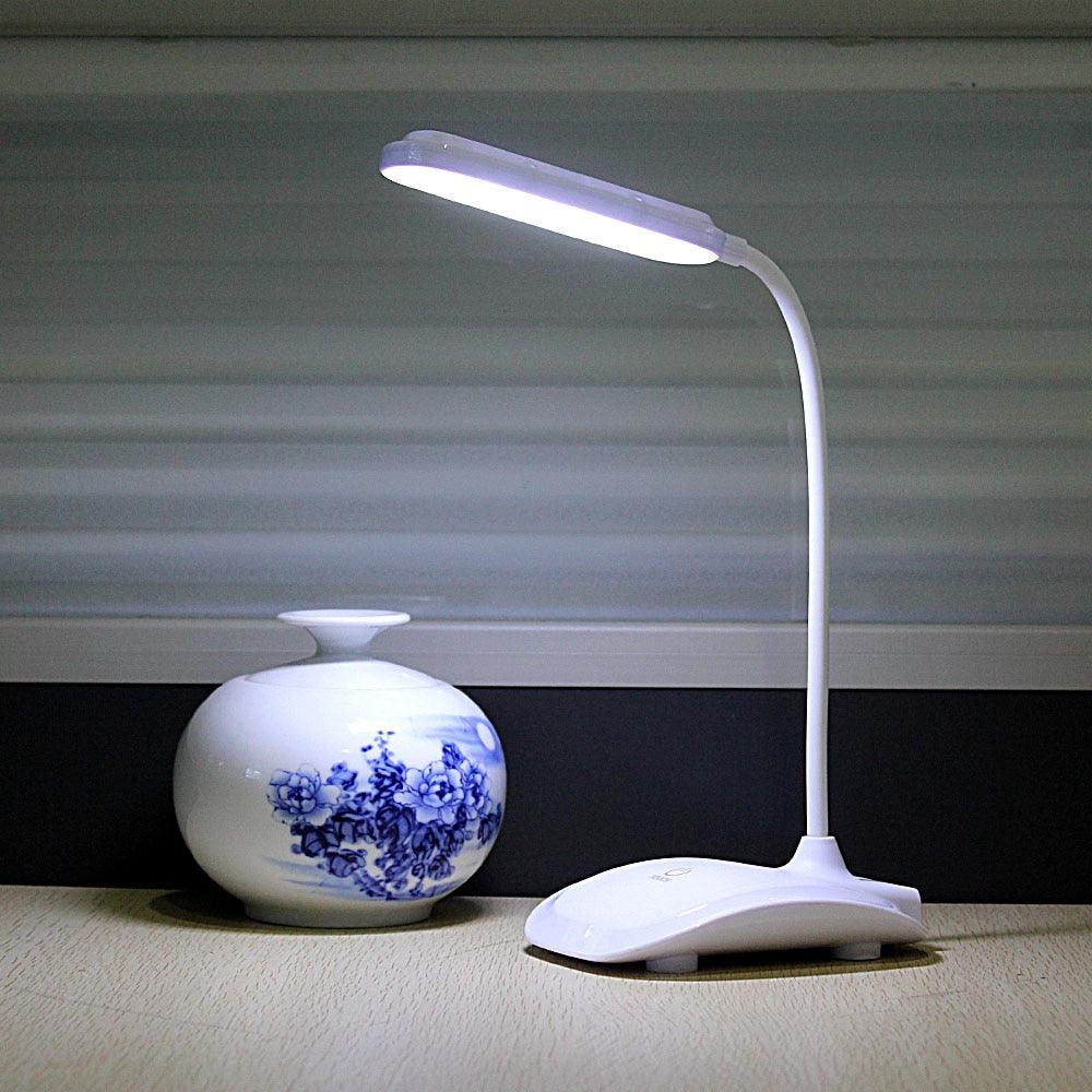 Dimmable cordless LED desk lamp with built-in battery and USB charging sitting on a bedside table.