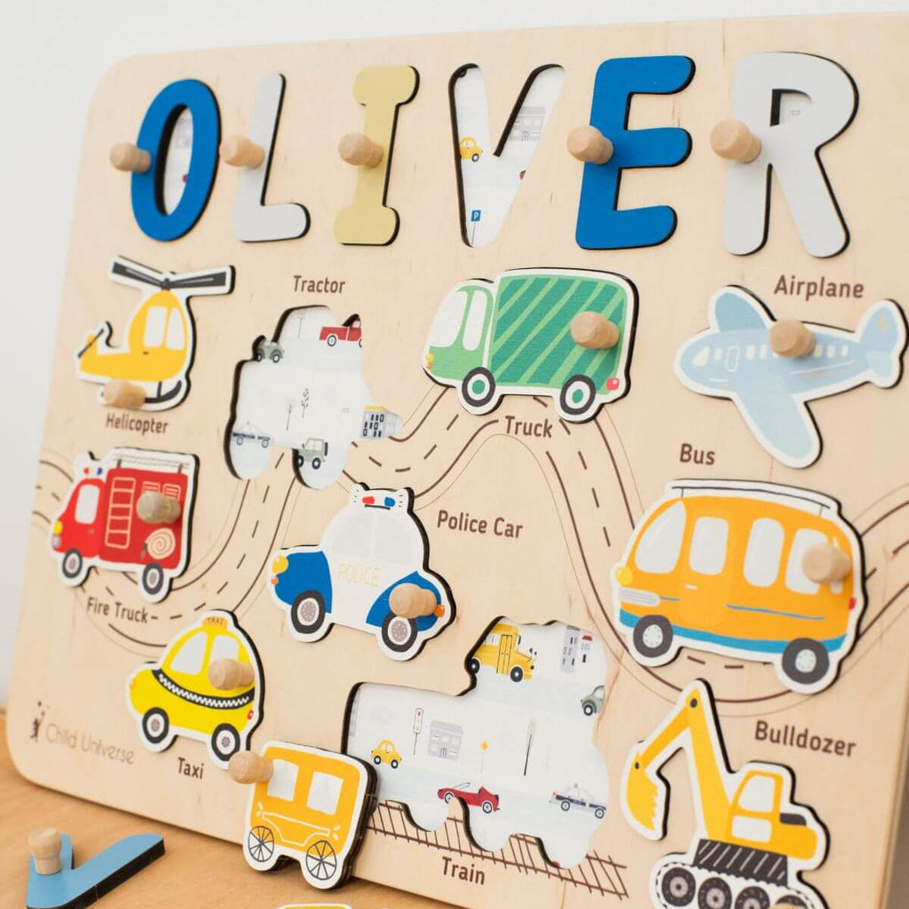 A wooden name puzzle board featuring colorful vehicle shapes for toddlers on a neutral background.