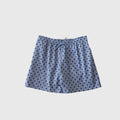 Men's board shorts in light blue and navy blue polka dot print with a drawstring waist.