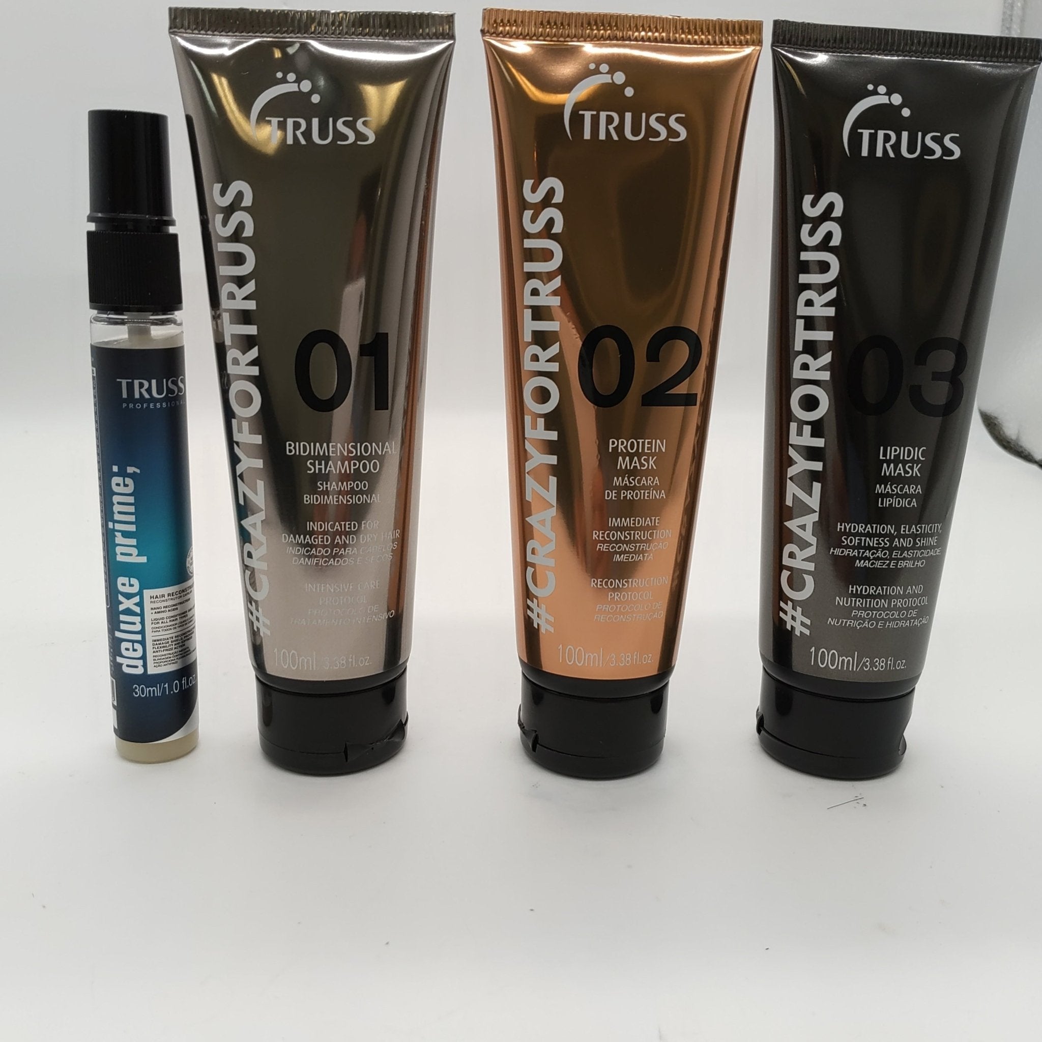 Truss High Impact Hair Protocol set in silver, bronze, and charcoal black packaging.