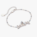 Silver-plated bracelet featuring a 3D tufted titmouse with blue-grey enamel wings, white belly, and crystal-adorned mistletoe.