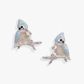 Close up of Tufted Titmouse bird stud earrings with blue-grey enamel and crystal berries on a polished silver finish.