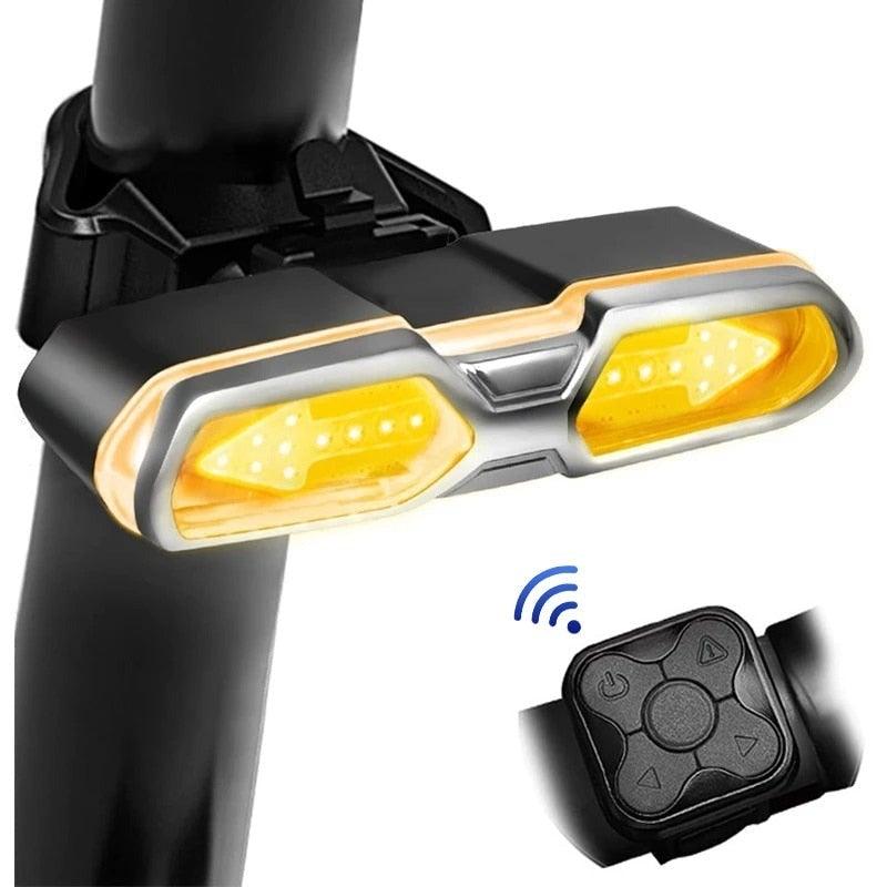 Close up of a rechargeable LED bike taillight with turn signals mounted on a road bicycle