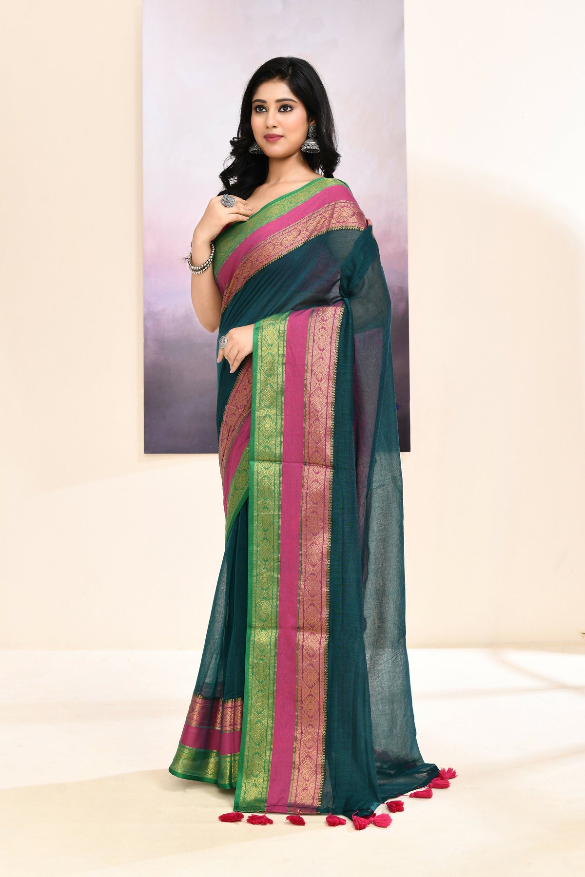 Teal cotton saree with intricate Zari border and embellishments
