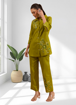 A woman wearing a stylish green cotton linen embroidered co-ord set for casual brunch
