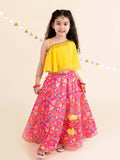 Girl wearing a bright yellow and pink traditional lehenga choli set