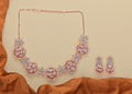 Golden White AD necklace set with brass construction and white stone embellishments
