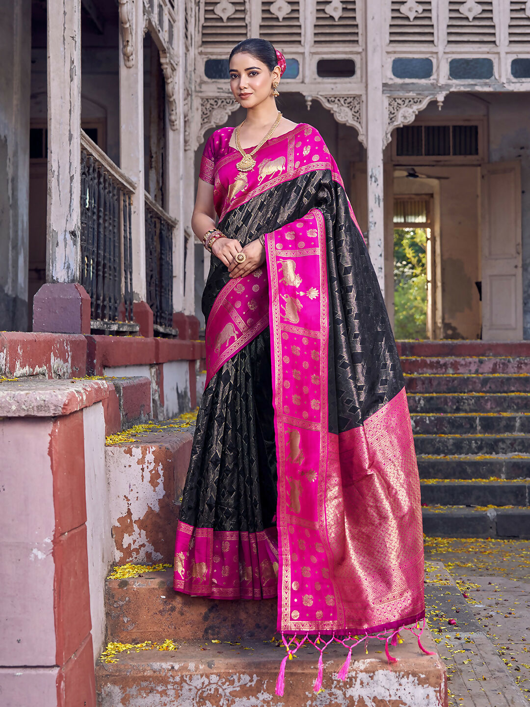 Black soft silk saree paired with a pink blouse, elegant ethnic attire.