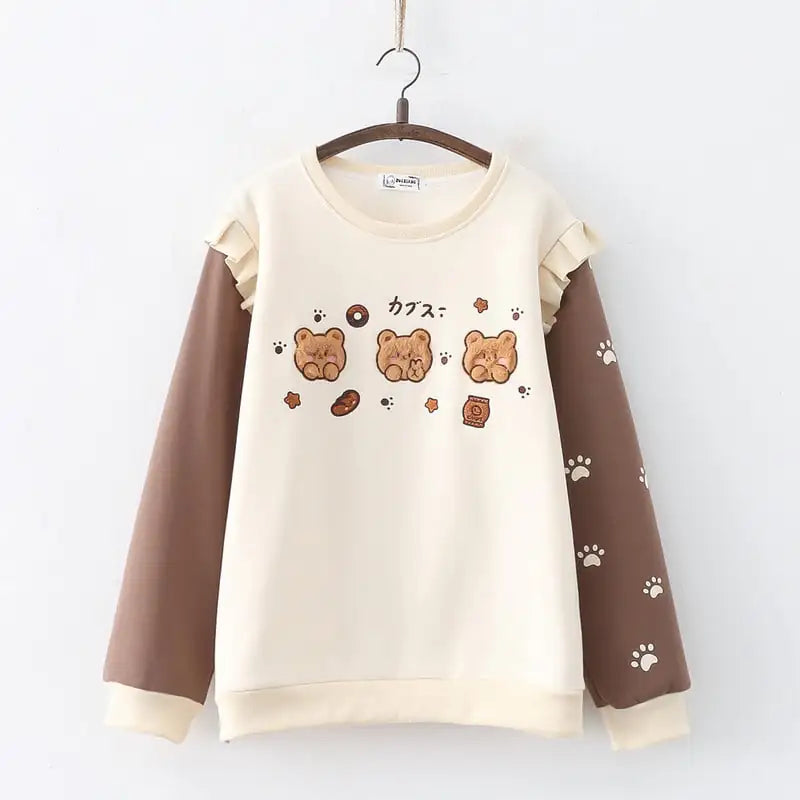 Women's crew neck fleece-lined pullover sweater featuring cartoon bear embroidery and paw print sleeves.