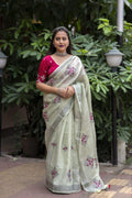 Green pure linen saree with silver zari embroidery and matching unstitched phantom silk blouse.